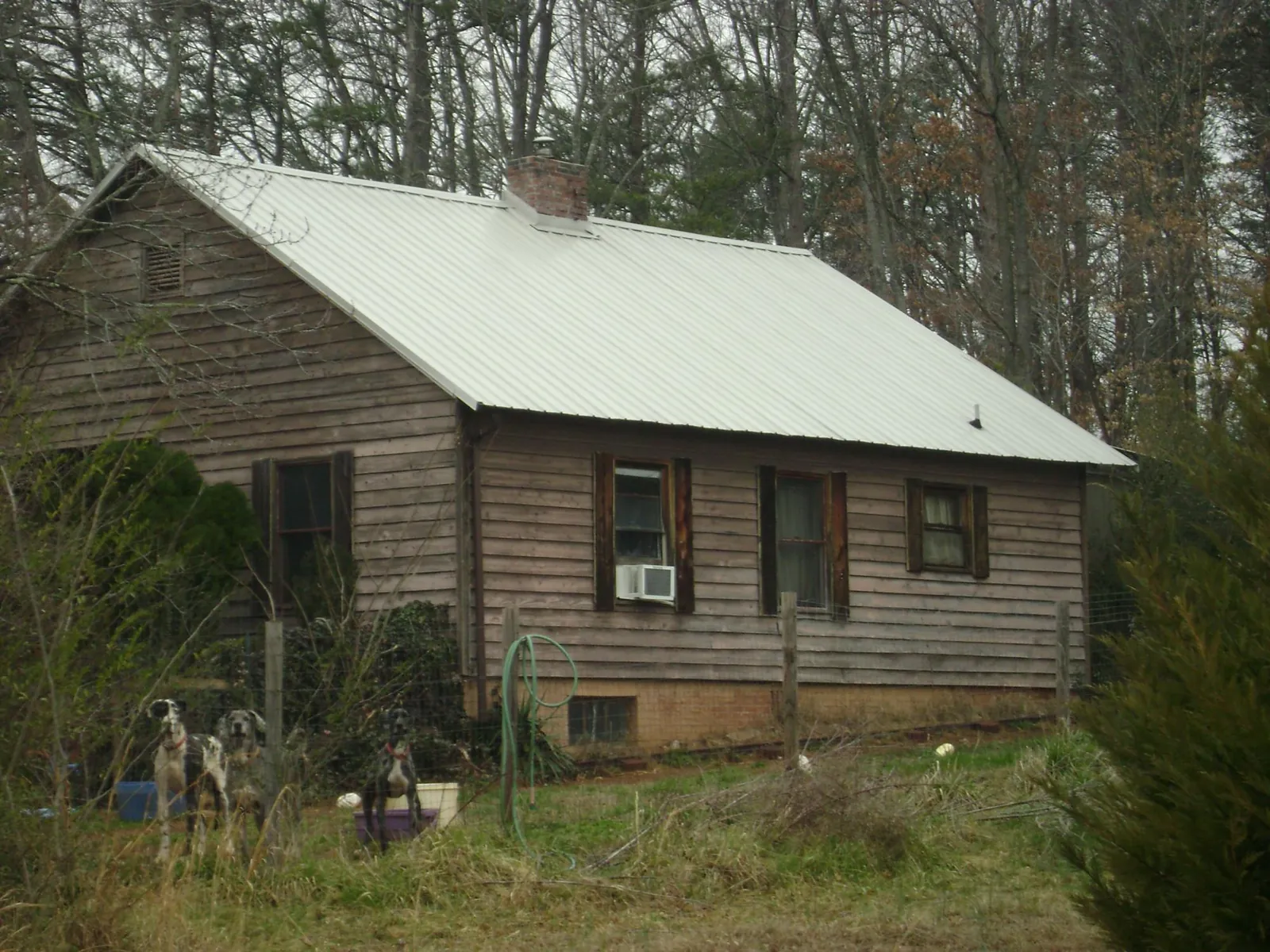 White metal roof on an old wood sided farmhouse, from a Metal Roof Installation job in Union City